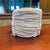 White Unlaced Danish Paper Cord 10 pound reel from HH Perkins on table in the HH Perkins office.